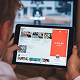 Person using a tablet to browse YouTube