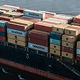 Cargo ship loaded with shipping containers from Maersk and other companies in port
