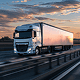 Semi-truck driving on the highway at sunset
