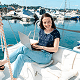 smiling woman working on a laptop while relaxing on a yacht at the marina