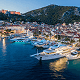 evening view of with luxury yachts docked and a coastal town in the background